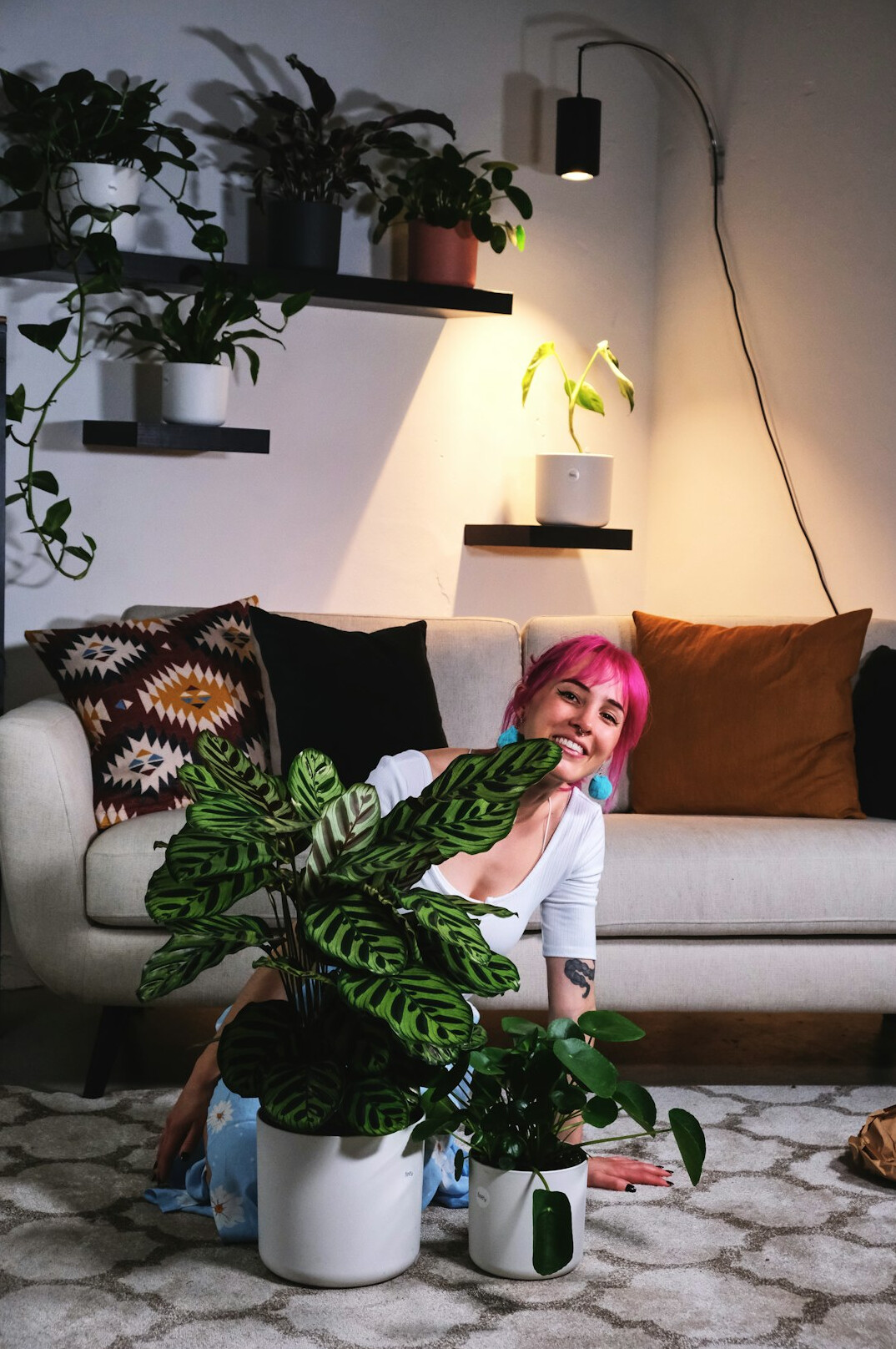 woman watering indoor plants